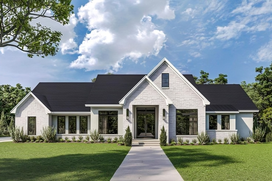 A white house with black roof and a green lawn